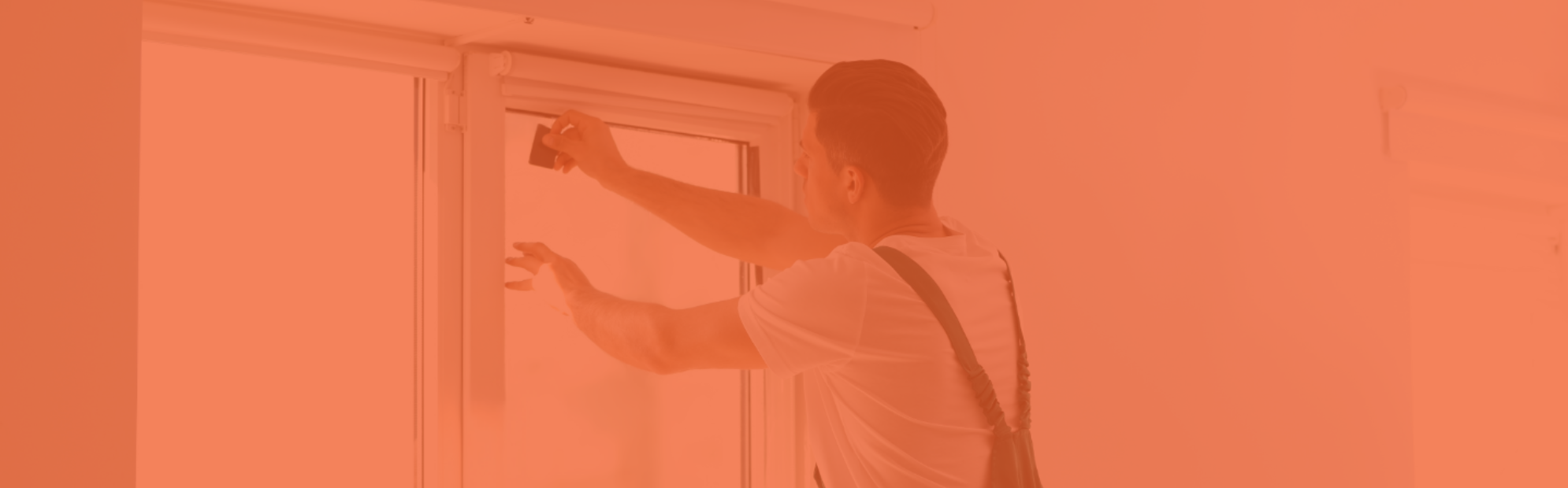 An installing dealer applies film to a window.